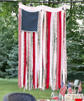 Rag American Flag Banner 4 X 2.3 Ft Totally Patriotic Decor for home porch or outdoor party shown hanging outdoors