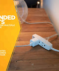 Slimline Flat Plug Extension Cord 6 Foot 16 Gauge 3 Conductor 3 Outlet Indoor White Wall Saver for Lamps Clocks and More displayed on table