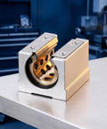 Top Rated Joinpaya 2pcs Br20uu Linear Bearing Blocks with Oilless Graphite Bronze Bushings close-up on metal table.