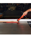 Get A Grip TPR Push Stick With Reversible Notches And Bright Orange Grip For Safer Woodworking And Precise Control Twelve And Three Quarters Inch Length being used on a table saw