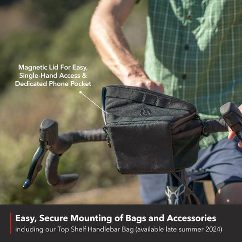 Cyclist with Top Shelf Aluminum Drop Bar with 50 or 70mm Rise and 44cm Width, featuring secure handlebar bag.