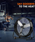 Heavy Duty Thirty Inch Drum Fan Packs A Boss 550W Motor Pumping Insane 14000 CFM Airflow On Three Speed Settings next to a gym user.