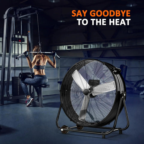 Heavy Duty Thirty Inch Drum Fan Packs A Boss 550W Motor Pumping Insane 14000 CFM Airflow On Three Speed Settings next to a gym user.