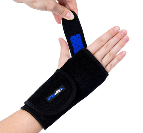 Person adjusting a black Right Hand Carpal Tunnel Wrist Brace For Men And Women Adjustable Wrist Splint With All Day Comfort.
