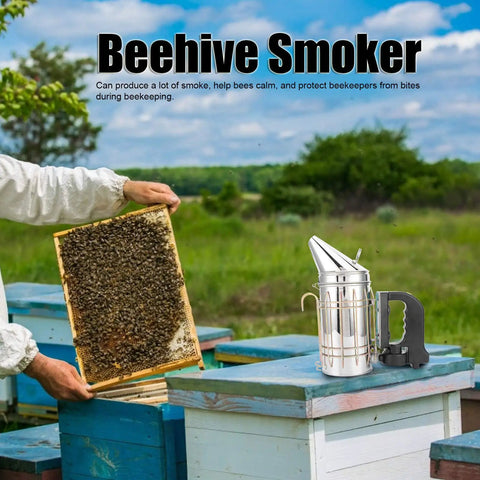 Heavy Duty Stainless Steel Electric Beekeeping Smoker With Heat Shield next to beehive frame in apiary setting.