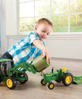 Child playing with Big Farm 7330 Tractor With Front Bale Mover And Bale Realistic Lights And Sounds Durable Toy Vehicle indoors