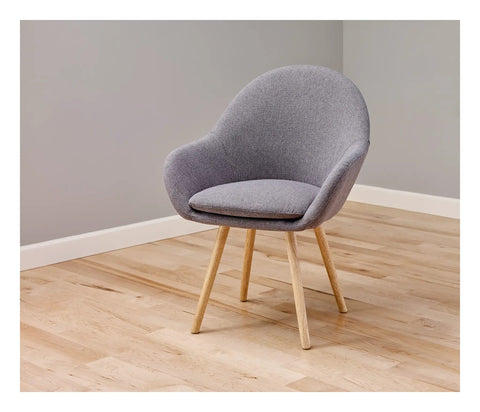 Gray chair on wooden floor showcasing Heavy Duty Self Adhesive Gripping Pads For Hard Surfaces One And A Half Inch Brown 8 Count No Slip Furniture Grippers That Keep Appliances And Lamps From Dancing And Staying Put On Floors And Tables.