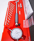 Front view of LLDSIMEX bore gauge set in a red case with interchangeable steel probes and dial indicator, 2-6 inch range.