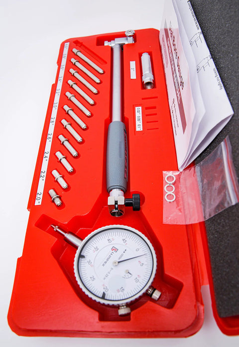 Front view of LLDSIMEX bore gauge set in a red case with interchangeable steel probes and dial indicator, 2-6 inch range.
