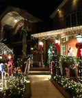 House decorated with Two Pack Solar String Lights With 100 LEDs On 33 Foot Copper Wire Outdoor Fairy Lights Waterproof IP44