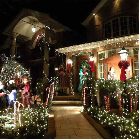 House decorated with Two Pack Solar String Lights With 100 LEDs On 33 Foot Copper Wire Outdoor Fairy Lights Waterproof IP44