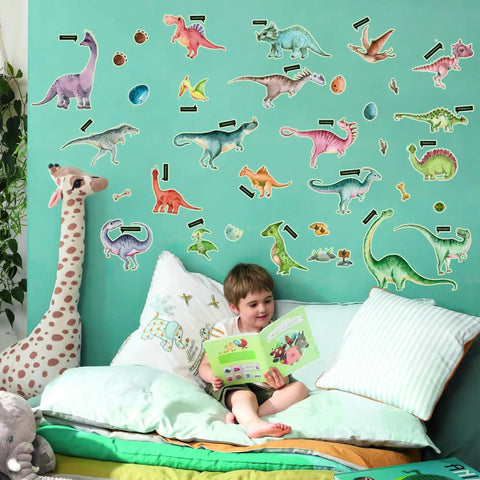 Child reading under dinosaur wall decals, featuring various colorful prehistoric creatures in a playful bedroom setting.