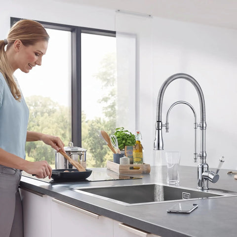 Ialtruistic 2-in-1 High Arc Pull Down Swivel Kitchen Faucet, Chrome in a modern kitchen with a woman cooking.