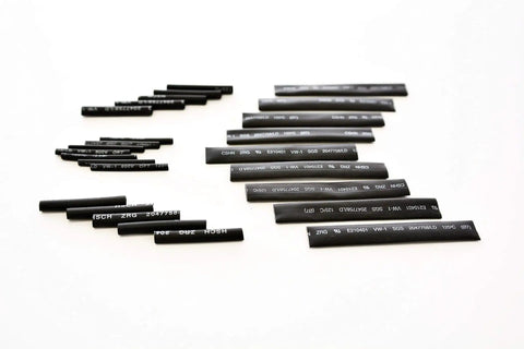 Assorted black heat shrink tubes from 2 To 1 Heat Shrink Tubing Kit For Wires And Cables, 127 Piece Assortment Of Wire Wrap Sleeve In Seven Sizes