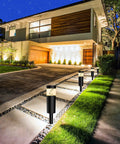 Modern driveway illuminated by Low Voltage 12V Outdoor Landscape Path Lights With Connectors 5W 500 Lumen Glare Free Warm White LED Bollard Walkway Lights For Garden Yard Lawn 8 Pack Waterproof IP65 in dusk setting.