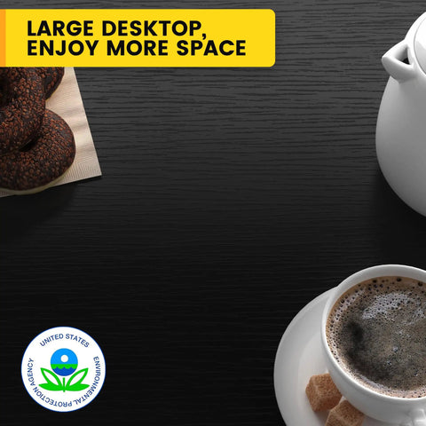 Large desktop showcasing a coffee cup with sugar, cookies on a napkin, and a teapot on a glossy black surface.