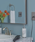 Tamper Resistant Self Test GFCI Outlet, 20 Amp, Magnesium Finish With Matching Wall Plate in a bathroom setting