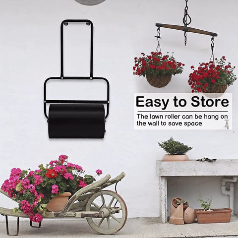 Heavy Duty Push Lawn Roller With 16 Inch Steel Drum Black Finish hung on a wall demonstrating easy storage in a garden setting