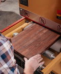 User operating Heavy Duty 16 Inch Open End Belt Sander 5 Hp 230V Single Phase Beast, feeding wood plank for sanding.