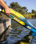 Person launching Sonicwake RC Boat 48 Inch Self Righting Brushless 8S Ready To Run into water near pier.