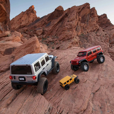 One Sixth Scale SCX6 Jeep Wrangler 4x4 Rock Crawler RTR With Two Speed Transmission And Beefed Up Front And Rear Suspension, AR90 Axles, Silver Finish, Batteries And Charger Not Included on rocky terrain with other RC models