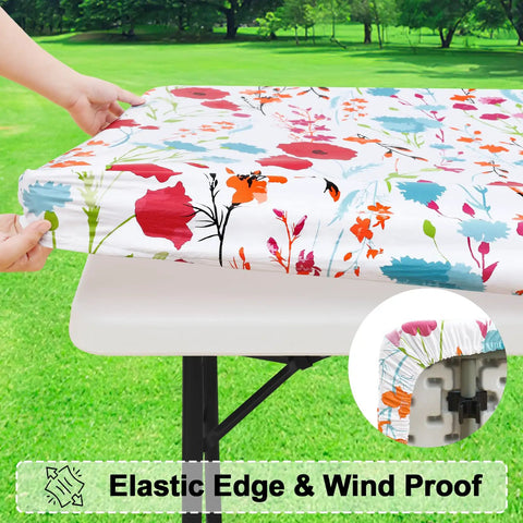 Floral 30x72 Inch Rectangle Vinyl Tablecloth with Elastic Edge snugly fitted on 6-foot table, ideal for outdoor use.