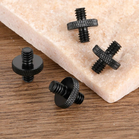 Four Pack One Quarter Inch Male To One Quarter Inch Male Tripod Screws on marble surface, precision stainless steel hardware.