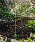 2 Pack 3-Arm Lawn Sprinkler With Adjustable Telescoping Base, 360 Degree Rotation, spraying water in garden setting.