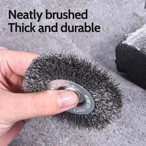 Hand holding coarse bristle from 18Piece Wire Wheel Cup Brush Set For Drills With One Quarter Inch Hex Shank, gray background