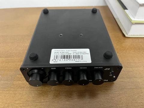Top view of BT30D Pro Two Point One Channel Bluetooth Subwoofer Amplifier with TPA3255 Chips, black, on a wooden surface