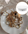 Electric Rotating Display Turntable For Jewelry And Watches With Adjustable Speed Rotation Anti Skid Base for showcasing jewelry on a white plate.