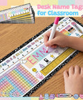 Child writing name on 60 Pcs Classroom Desk Name Tags Set With Alphabet Number Line 100 Chart Addition And Ruler For 1st Through 3rd Grade Kindergarten And Preschool Easy Desk Organization And Student Identification Must Haves