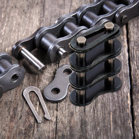Rock Solid Heavy Duty Single Speed Bicycle Chain Link Connectors 10 Pack Master Link Replacement Pins on wooden surface.