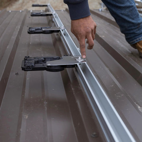 Top Shelf Micro Inverter With Standard Mc4 Connectors Designed For 320 To 540 Watt Solar Panels, person adjusting connector on solar panel rail.