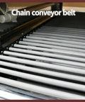 Premium 220V Shrink Tunnel Packaging Machine Heat Shrink Wrapper with heavy duty chain conveyor belt, close-up view of conveyor.