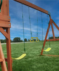 Atlantis Cedar Wood Swing Set With Wave Slide And Raised Clubhouse Featuring Rock Wall, Belt Swings, Trapeze on grass