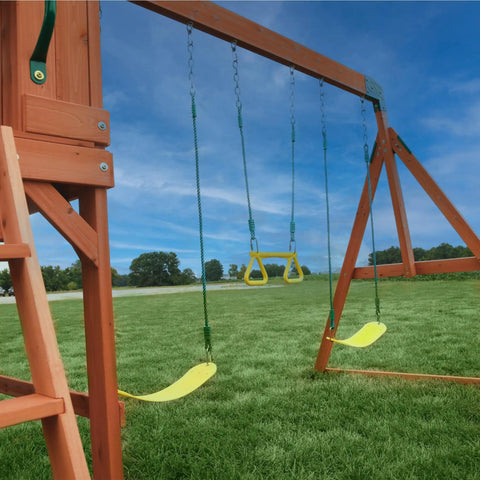 Atlantis Cedar Wood Swing Set With Wave Slide And Raised Clubhouse Featuring Rock Wall, Belt Swings, Trapeze on grass