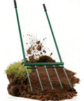 Beast Mode 5 Tine Broad Fork Garden Tool with 58 Inch Ergonomic Handle breaking through soil