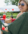 Woman relaxing in a Hanging Hammock Chair For Patio With Plush Headrest And Armrests Outdoor Swing Seat With Cup Holders in a garden setting.