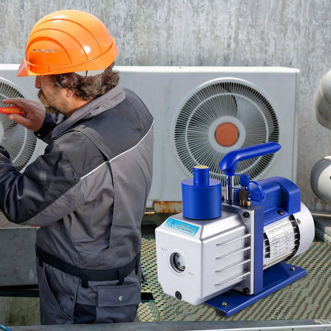 Heavy Duty 4.8 CFM 1/3 HP Auto AC Vacuum Pump With Integrated Manifold And Anti Reflex Oil Solid Die Cast Housing positioned near technician.