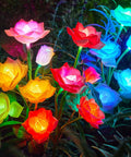 Solar Garden Lights Outdoor Decorative 3 Pack Rose Flower Pathway Lights, 7 Color Changing LEDs illuminating vibrant fabric roses