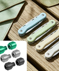 Get That Slick Grip On Your Blade With These Heavy Duty Replacement Thumb Studs Made For The Benchmade 535 Bugout To Guarantee Quick Deployment And Crisp Handling In Silver Black And Green For EDC Fans. Image shows colorful thumb studs and pocket knives on wooden surface.