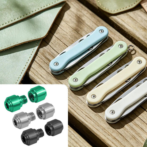 Get That Slick Grip On Your Blade With These Heavy Duty Replacement Thumb Studs Made For The Benchmade 535 Bugout To Guarantee Quick Deployment And Crisp Handling In Silver Black And Green For EDC Fans. Image shows colorful thumb studs and pocket knives on wooden surface.