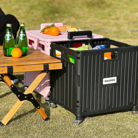 Folding Utility Cart With Lid And Basket On Four 360 Degree Rotating Wheels in use outdoors next to a wooden table with drinks and oranges
