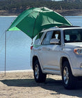 SUV Sport Multi Use Outdoor Shade Shelter Tent Camping Awning With Three Poles Two Legs And Carry Bag Ideal For Tailgates Beach Trips And Backcountry Expeditions Jolly Green attached to SUV by water