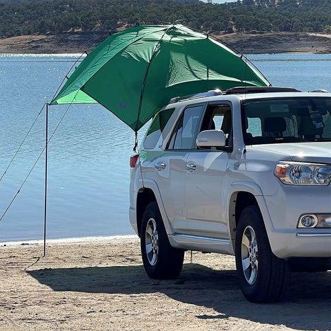 SUV Sport Multi Use Outdoor Shade Shelter Tent Camping Awning With Three Poles Two Legs And Carry Bag Ideal For Tailgates Beach Trips And Backcountry Expeditions Jolly Green attached to SUV by water
