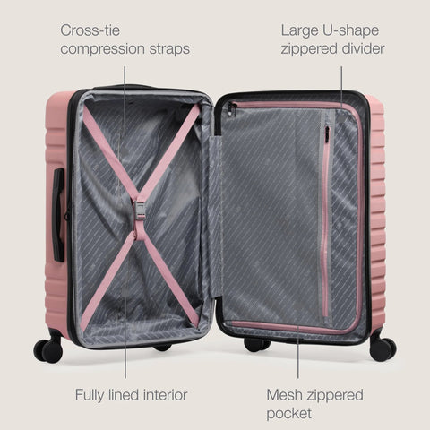 Open rose-pink U.S. Traveler expandable hardside luggage; left shows pink cross-tie straps, right has mesh zippered divider.