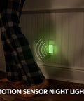 Person walking near a Three Pack Emergency Night Lights With Dusk To Dawn Sensor And Motion Activation Five In One Multi Color LED Mood Lights