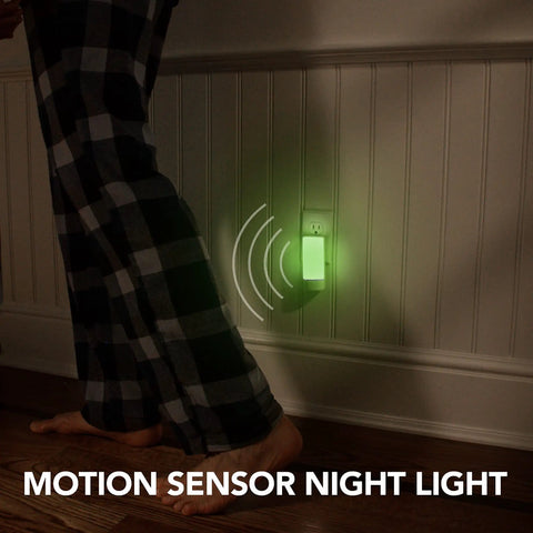 Person walking near a Three Pack Emergency Night Lights With Dusk To Dawn Sensor And Motion Activation Five In One Multi Color LED Mood Lights