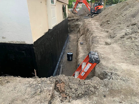 Kickass Rubberized Waterproofing Sealant For Foundations And Flat Low Slope Roofs Concrete Wood Metal Black Five Gallon applied to a foundation wall.